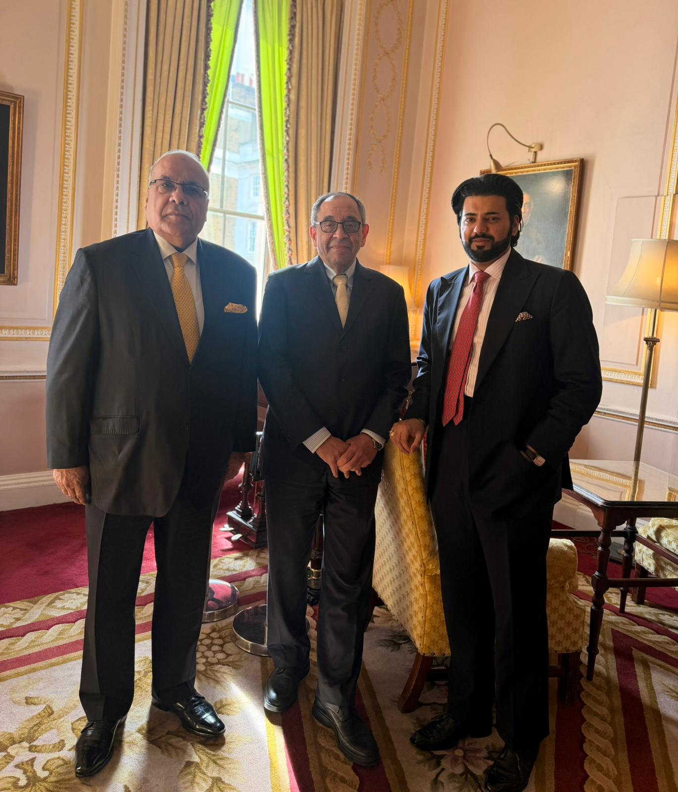 Xyra Group principals in a grand wood-panelled dining room